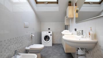 Shower, hair dryer, towels, toilet paper