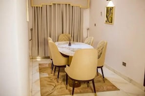 Deluxe Room, Balcony, City View | Dining room - TAJ SUITES  (Ado Ekiti)