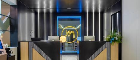 A modern reception area with a sleek design, featuring a prominent logo and a reception desk.