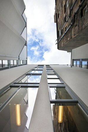 A modern building with reflective glass windows and a clear sky. - Student Only Buccleuch Street (Edinburgh)