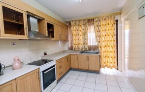 Deluxe Apartment, 2 Bedrooms, Balcony, City View | Private kitchen | Full-sized fridge, microwave, oven, stovetop - Altis Apartments (Kigali)