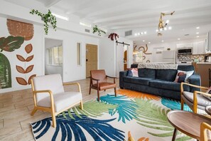 A modern living room with a sofa, chairs, and a colorful rug. - Heated Pool/5 mins to St Pete Beach-Slps 10 (St. Petersburg)