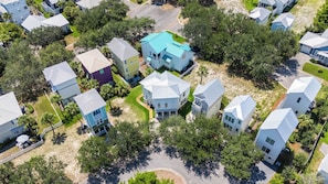 An aerial view of a residential area with houses, roads, and greenery. - Lagniappe at Blue Mountain by Avantstay 4BR Coastal Home + Walk to the Beach Community Pool + Gym (Santa Rosa Beach)