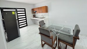 A modern kitchen with wooden cabinets and a built-in stove.