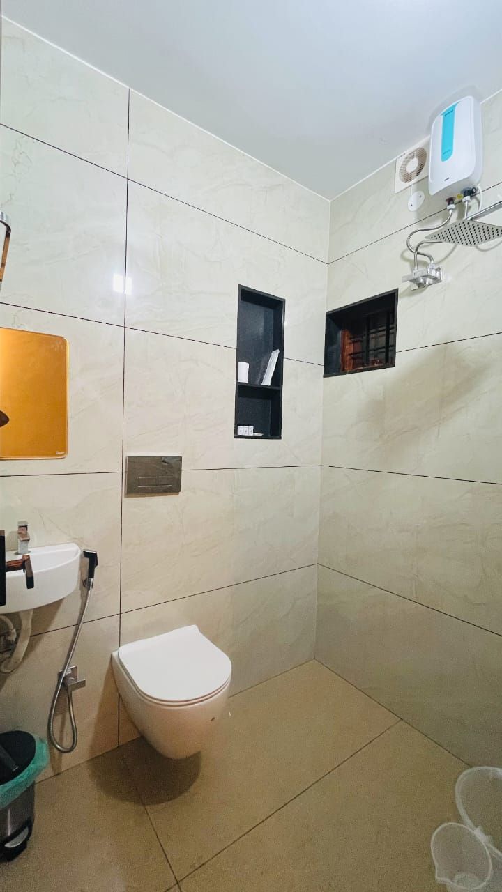 A bathroom with a toilet, sink, and shower.