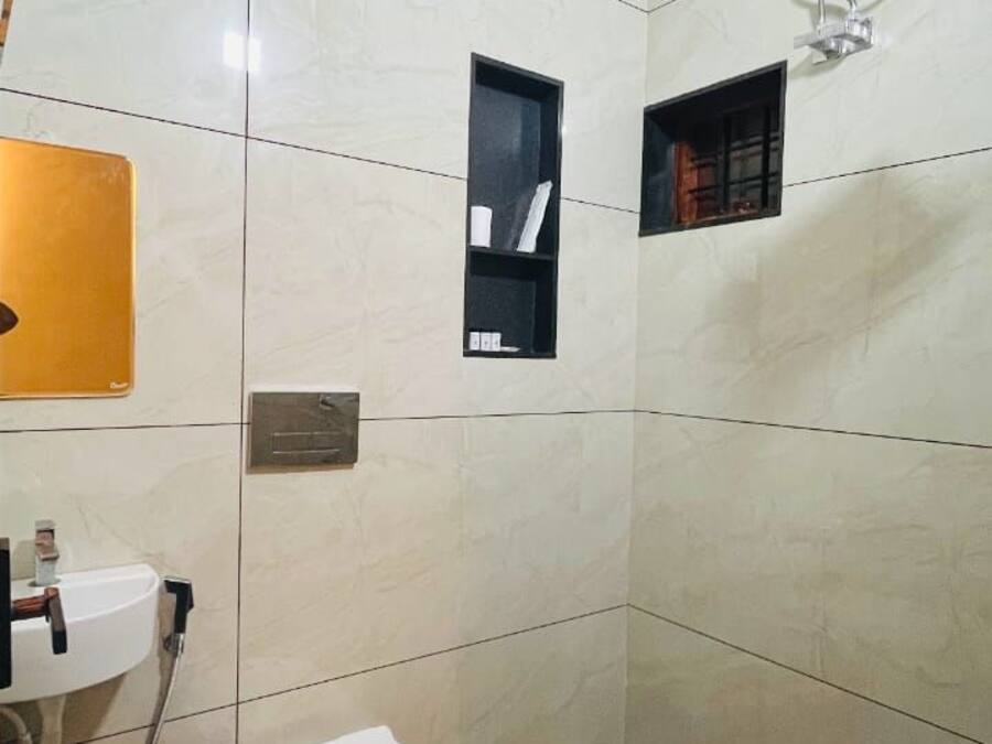 A bathroom with a toilet, sink, and shower.