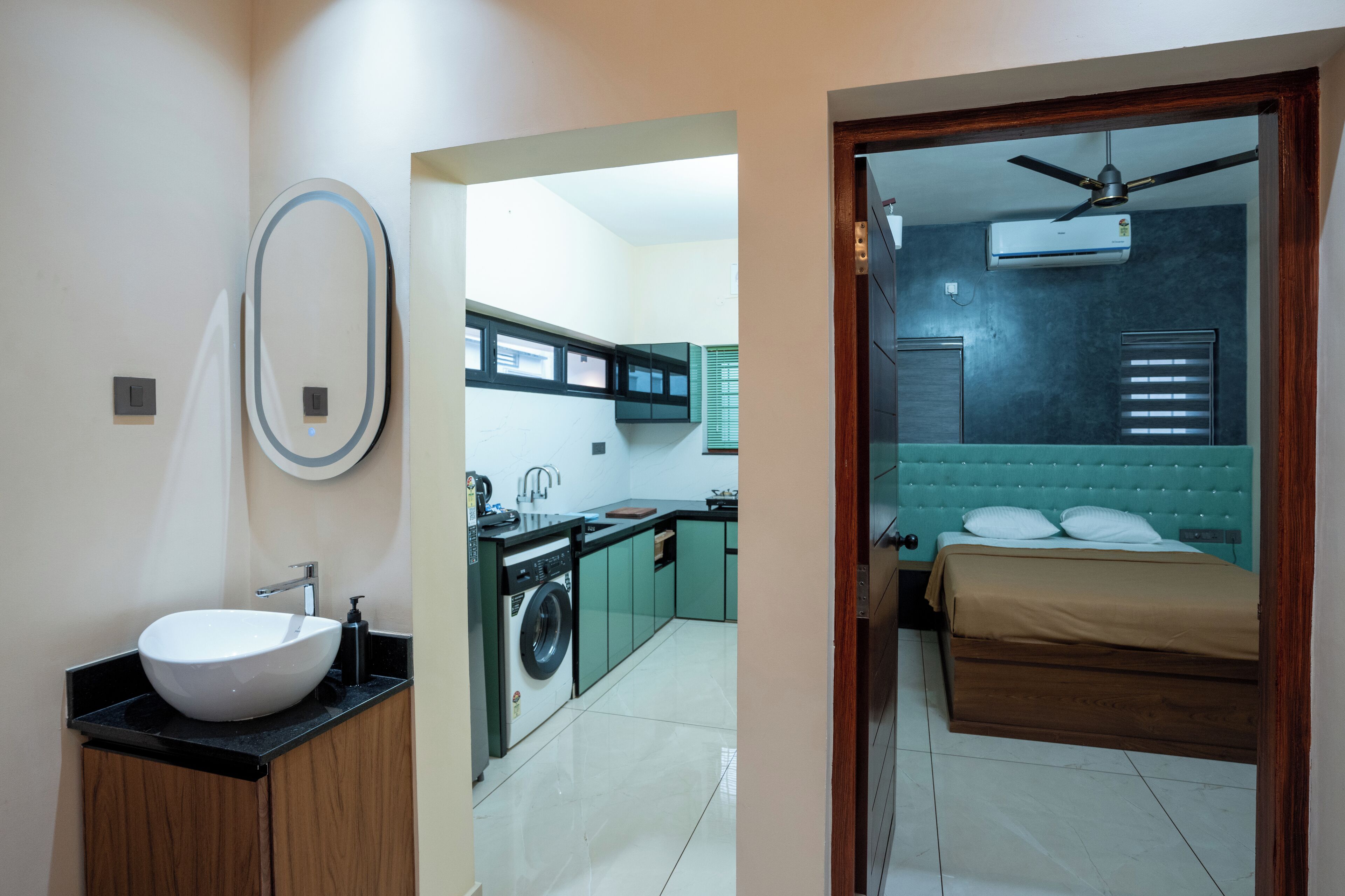 A modern bathroom with a sink, mirror, and toilet.