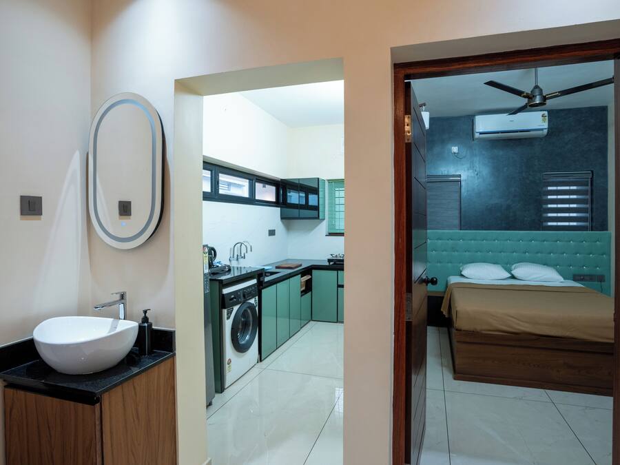 A modern bathroom with a sink, mirror, and toilet.