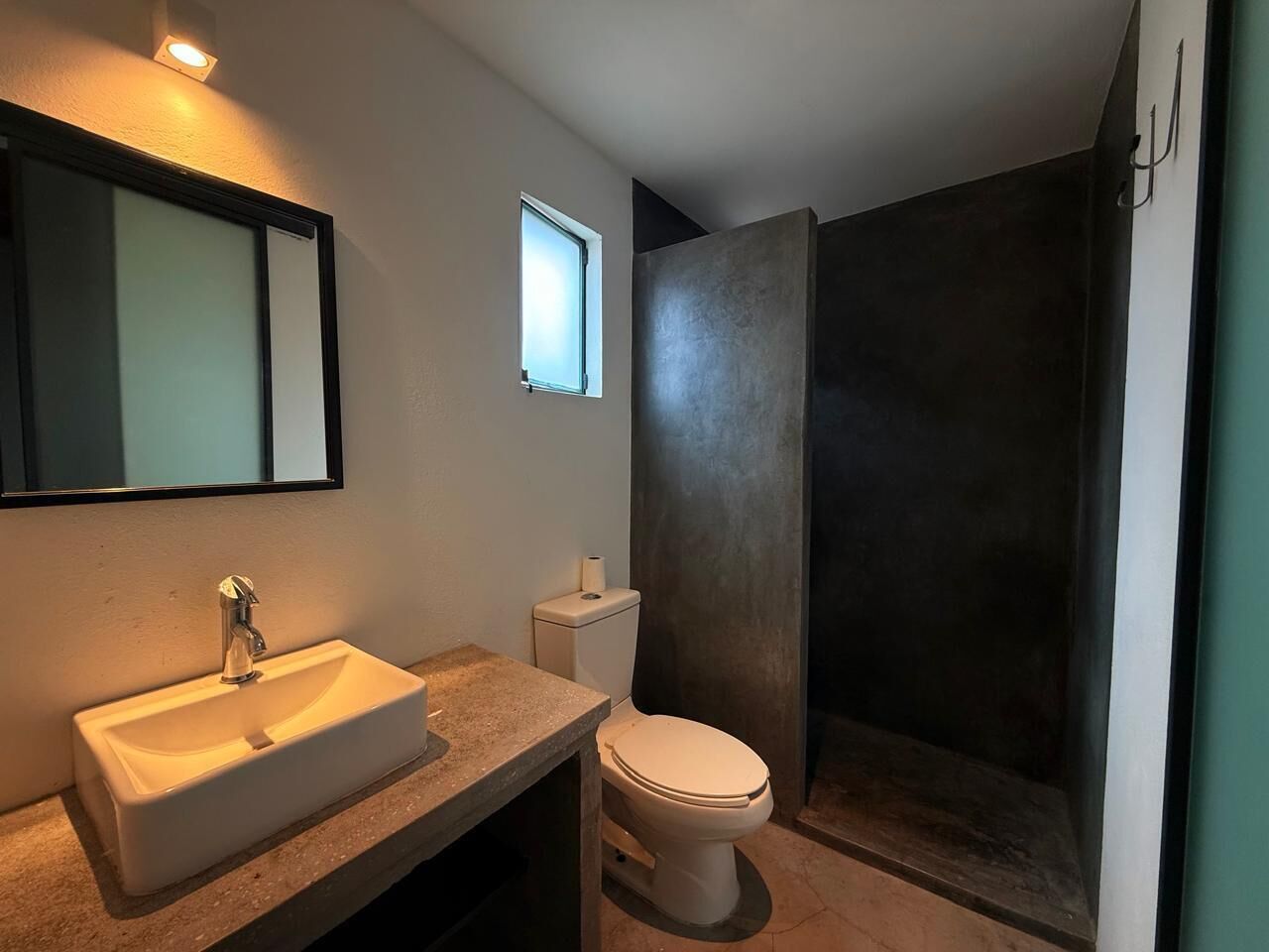 A bathroom with a sink, toilet, and shower.