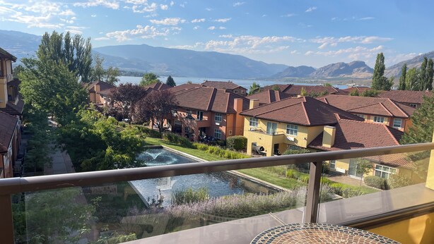 A residential area with houses, a swimming pool, and a mountain view.