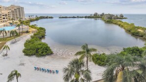 A coastal resort with a beachfront, a swimming pool, and a hotel building. - Cozy 2-bedroom condo with heated pool, fitness room, game room, Gulf Front (Hudson)