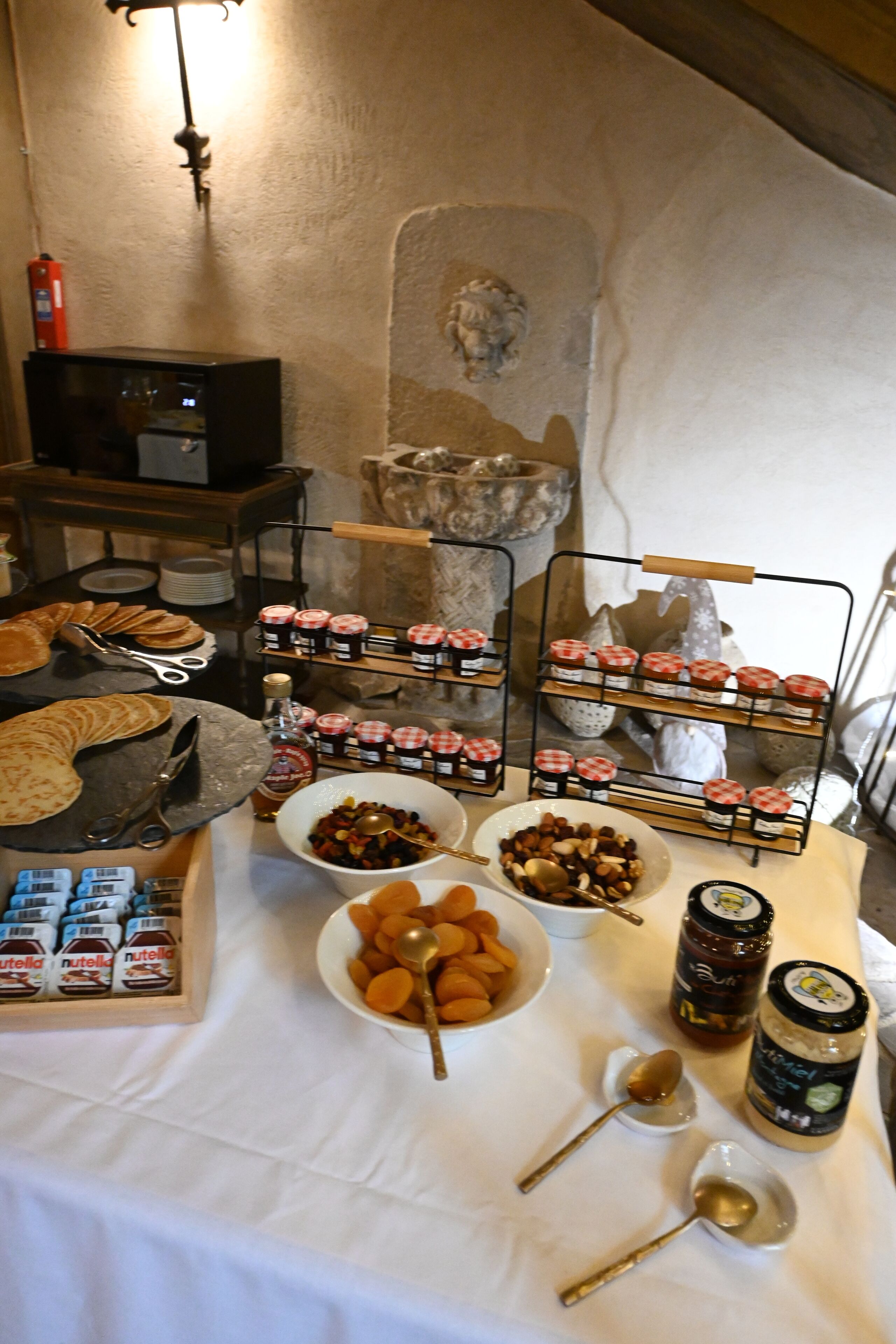 A breakfast buffet with various food items and condiments.
