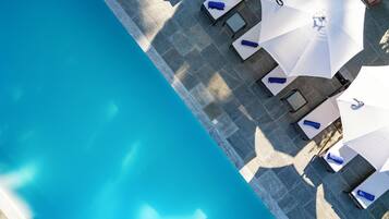 Een seizoensgebonden buitenzwembad en parasols bij het zwembad