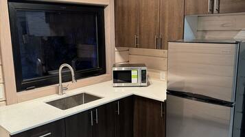 Fridge, microwave, stovetop, cookware/dishes/utensils