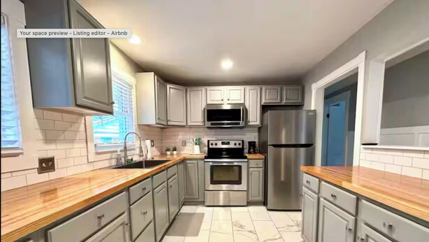 A modern kitchen with grey cabinets, a stainless steel refrigerator, and a wooden countertop. - 1 Mile to Parris Island - 3BR Beaufort Home - Sleeps 6 (Beaufort)