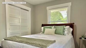 A neatly made bed with a green throw, a window with blinds, and a closed door. - 1 Mile to Parris Island - 3BR Beaufort Home - Sleeps 6 (Beaufort)