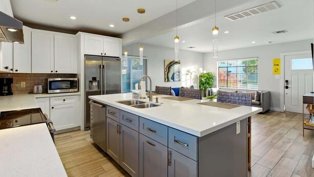 A modern kitchen with white cabinets, stainless steel appliances, and pendant lighting. - Walk 2 Old Town, Sparkling Pool, Fire Pit, Oasis (Scottsdale)