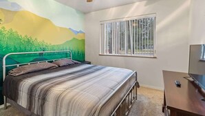 A bedroom with a bed, a ceiling fan, a window, and a TV. - Spacious 4-BR Home, Near Fool Hollow Lake (Show Low)