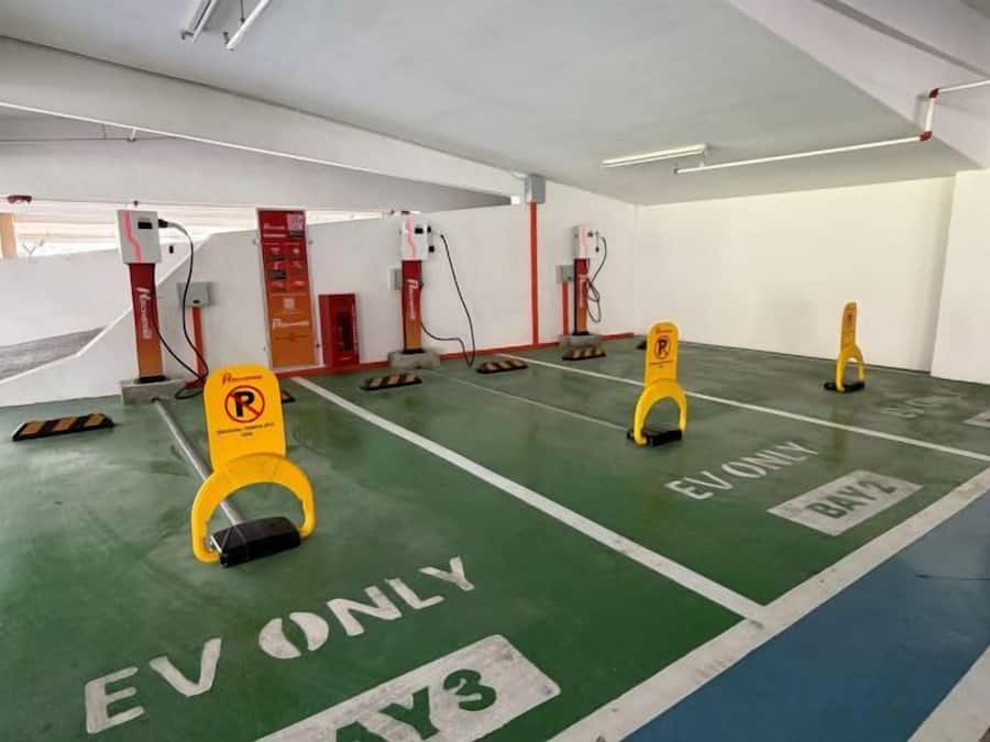 A parking area with EV ONLY markings and charging stations.