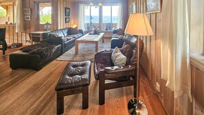 A cozy living room with a fireplace, leather sofas, a coffee table, and a lamp. - Awesome home in Eggedal with sauna (Eggedal)