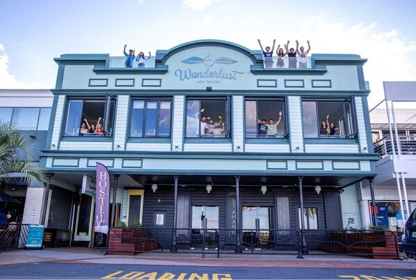 A building with a sign reading "Wanderlust New Zealand" and "Hostel St. Amant." - Wanderlust NZ (Tauranga)