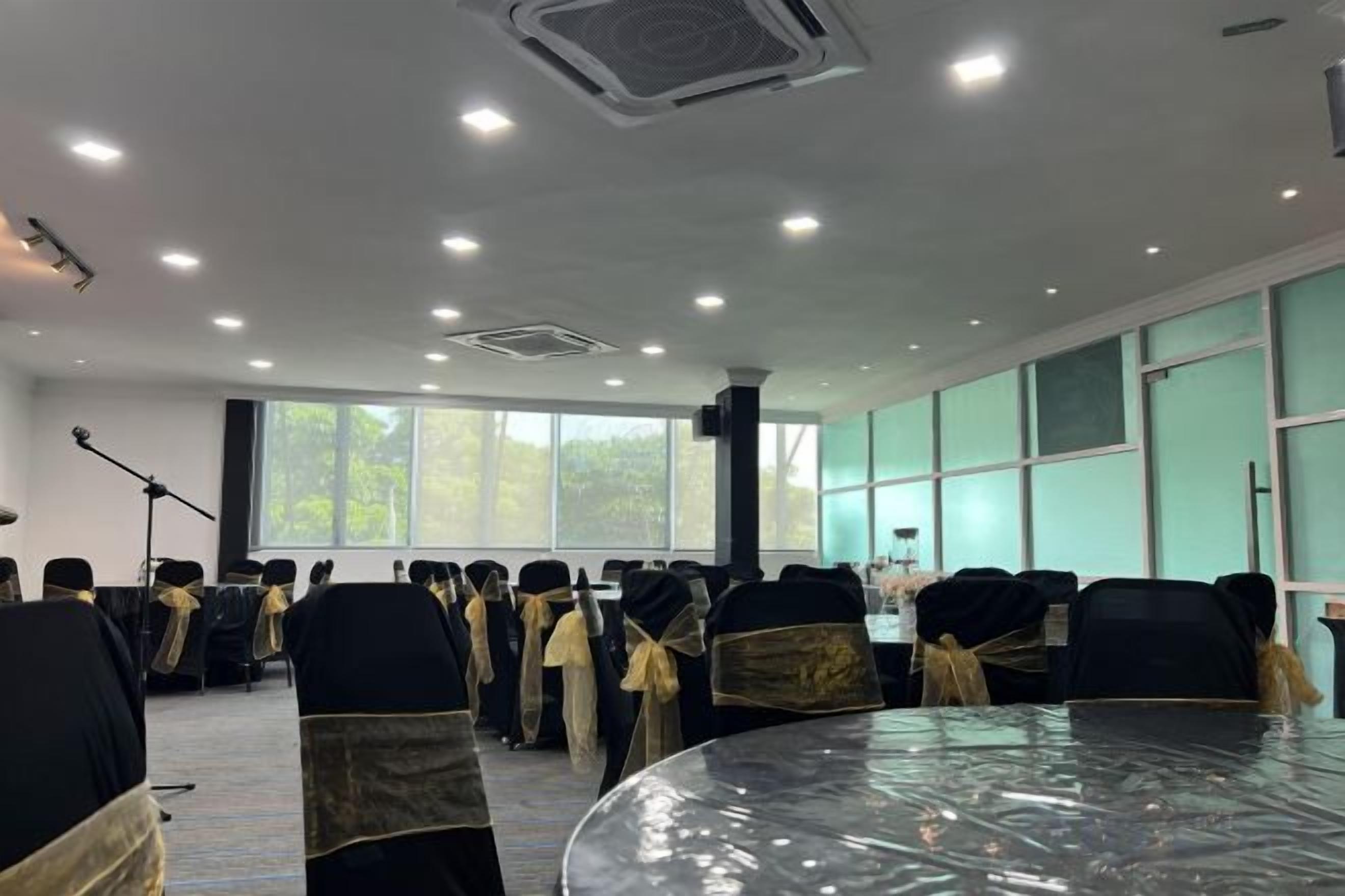 A conference room with round tables, chairs, and a large window.