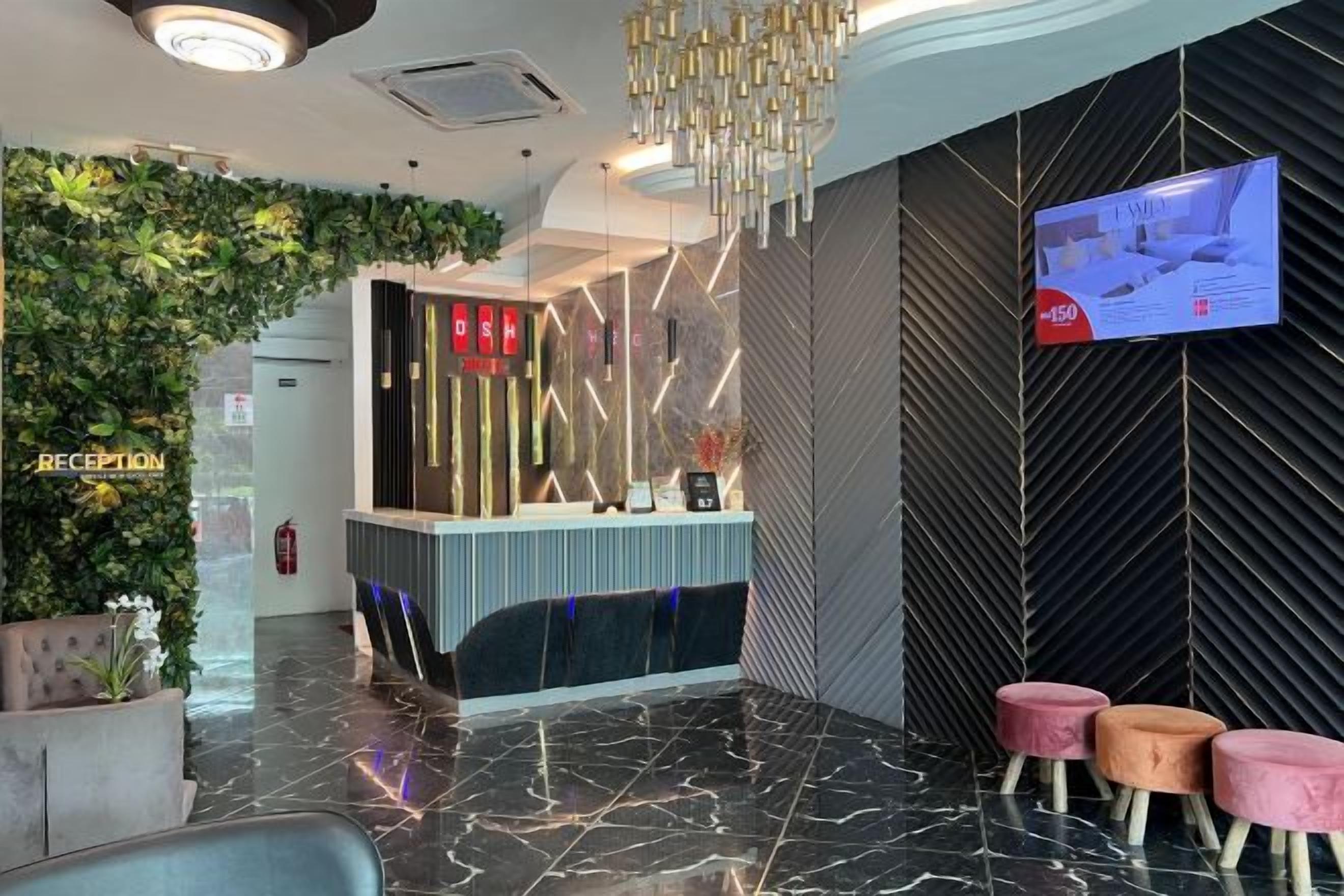 A reception area with a reception desk, a TV screen, and a reception sign.