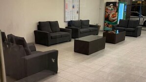 A modern waiting area with black sofas and a central coffee table. - Ayuman Suites, Gombak with KL City View (Gombak)