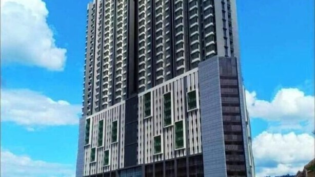 A high-rise building with a modern architectural design, featuring a mix of glass and metal elements. - Ayuman Suites, Gombak with KL City View (Gombak)