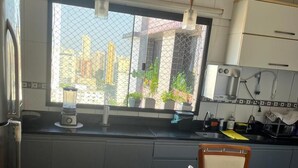 A kitchen with a large window, a blender, a coffee maker, and a chair. - 🌍 COP30 in Belém – Stay in Style and Comfort! 🏢 High floor | 220 m² (Belém)