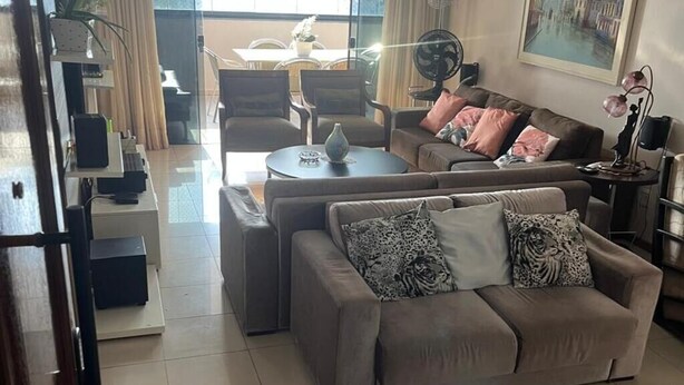 A spacious living room with a sofa set, a dining area, and a large window providing natural light. - 🌍 COP30 in Belém – Stay in Style and Comfort! 🏢 High floor | 220 m² (Belém)