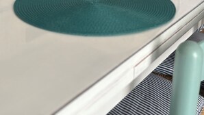 A kitchen with a white countertop, teal placemats, and a white decorative shell. - Sofia House, close to the center and the sea (Torre San Giovanni)