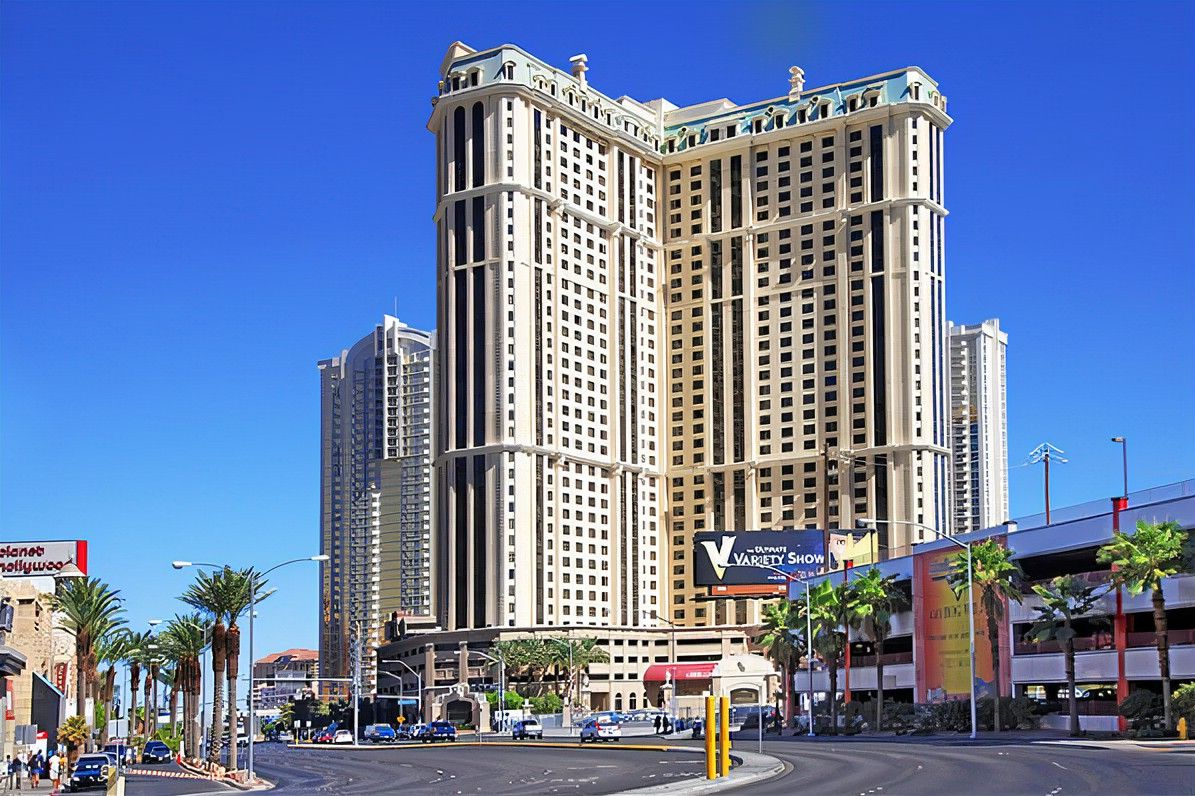 A high-rise hotel with a modern design, featuring multiple balconies and a prominent sign for the Variety Show.