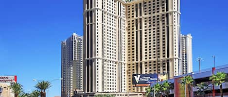 A high-rise hotel with a modern design, featuring multiple balconies and a prominent sign for the Variety Show.