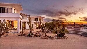 A modern two-story building with a desert garden featuring cacti and rocks. - Trendy studio with incredible ocean views (Todos Santos)
