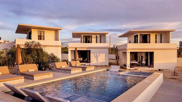 A modern pool area with lounge chairs and a pool. - Trendy studio with incredible ocean views (Todos Santos)