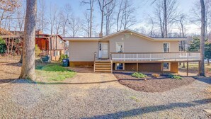 A single-story house with a front porch, a covered entryway, and a small deck. - Lakefront Access - Hour from DC - Kayaks Provided (Locust Grove)