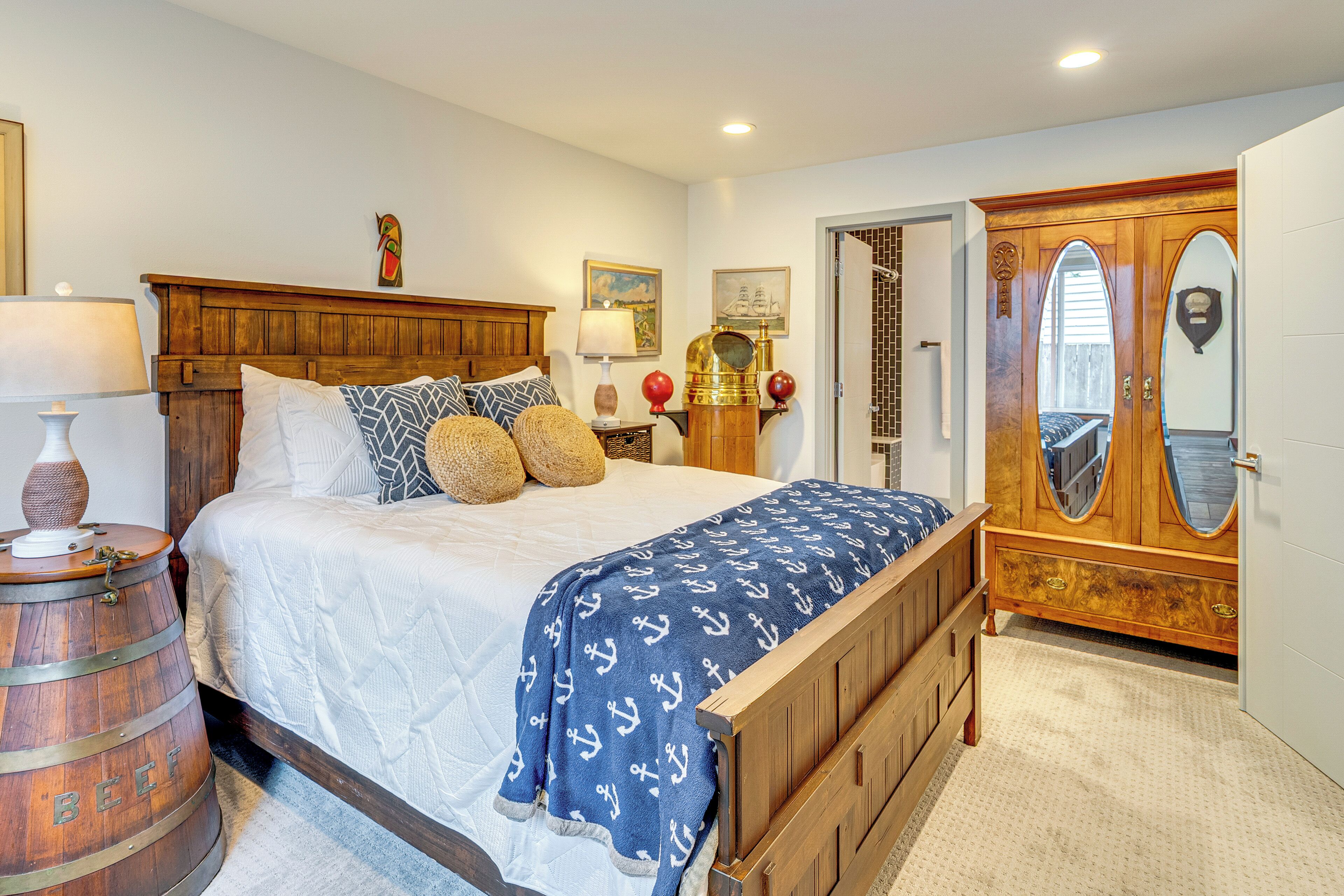 A bedroom with a wooden bed, a large mirror, and a wooden wardrobe.