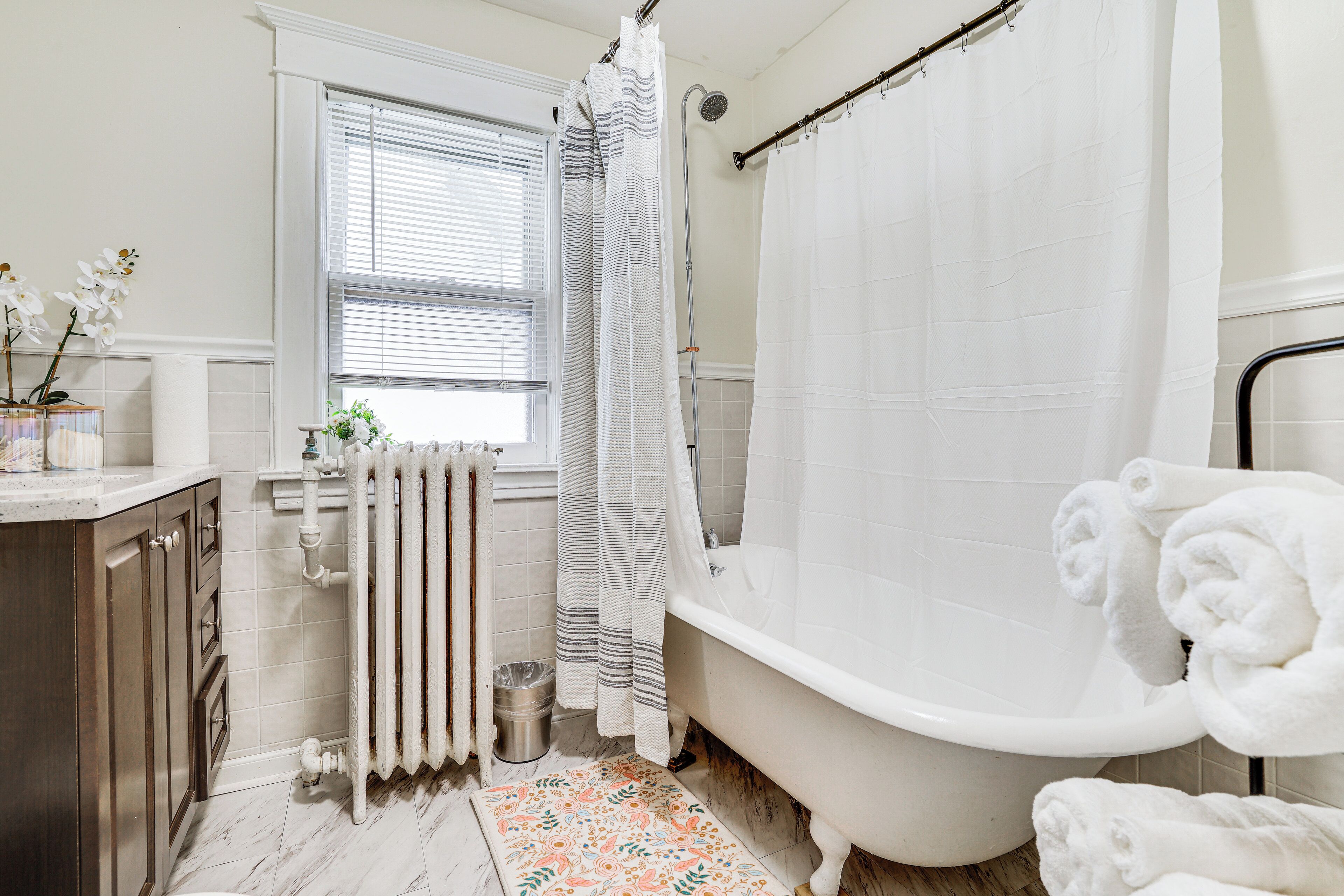 A bathroom with a bathtub, a shower, a toilet, and a sink.