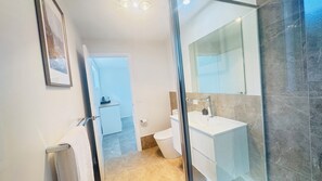 Shower, hair dryer, towels, soap