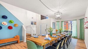 A dining area with a wooden table, chairs, and a bench. - The Painted Paddle: Pool, HotTub, Pickleball Court (Lake Dallas)