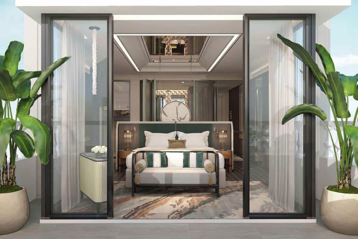 A modern bedroom with a large bed, bedside tables, and a view through glass doors.