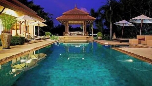 A swimming pool with a gazebo in the center, surrounded by lounge chairs and umbrellas. - Laguna Waters - Lake View Villa, 5 Bedrooms (Bang Tao)