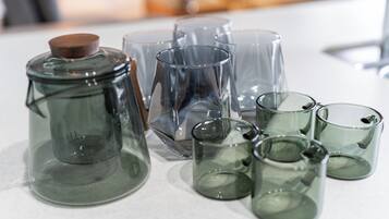 A collection of clear glass containers of various shapes and sizes on a white surface.