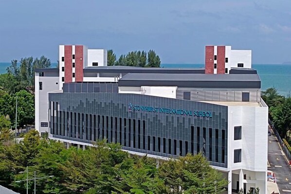 A modern building with a prominent sign reading "Stowes International School". - JazzA Suite by Homey Planet (Tanjung Tokong)