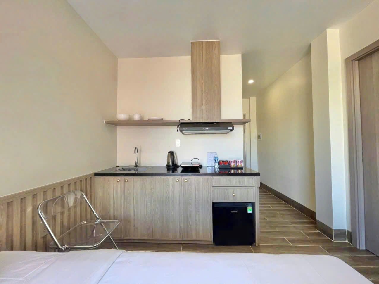 A modern kitchen with a built-in stove, sink, and a compact dishwasher.