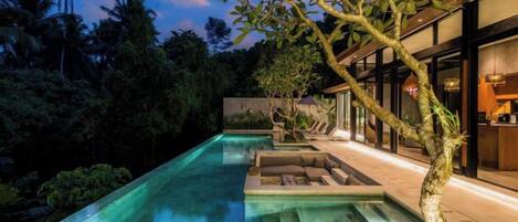 A swimming pool with a view of a building and trees.