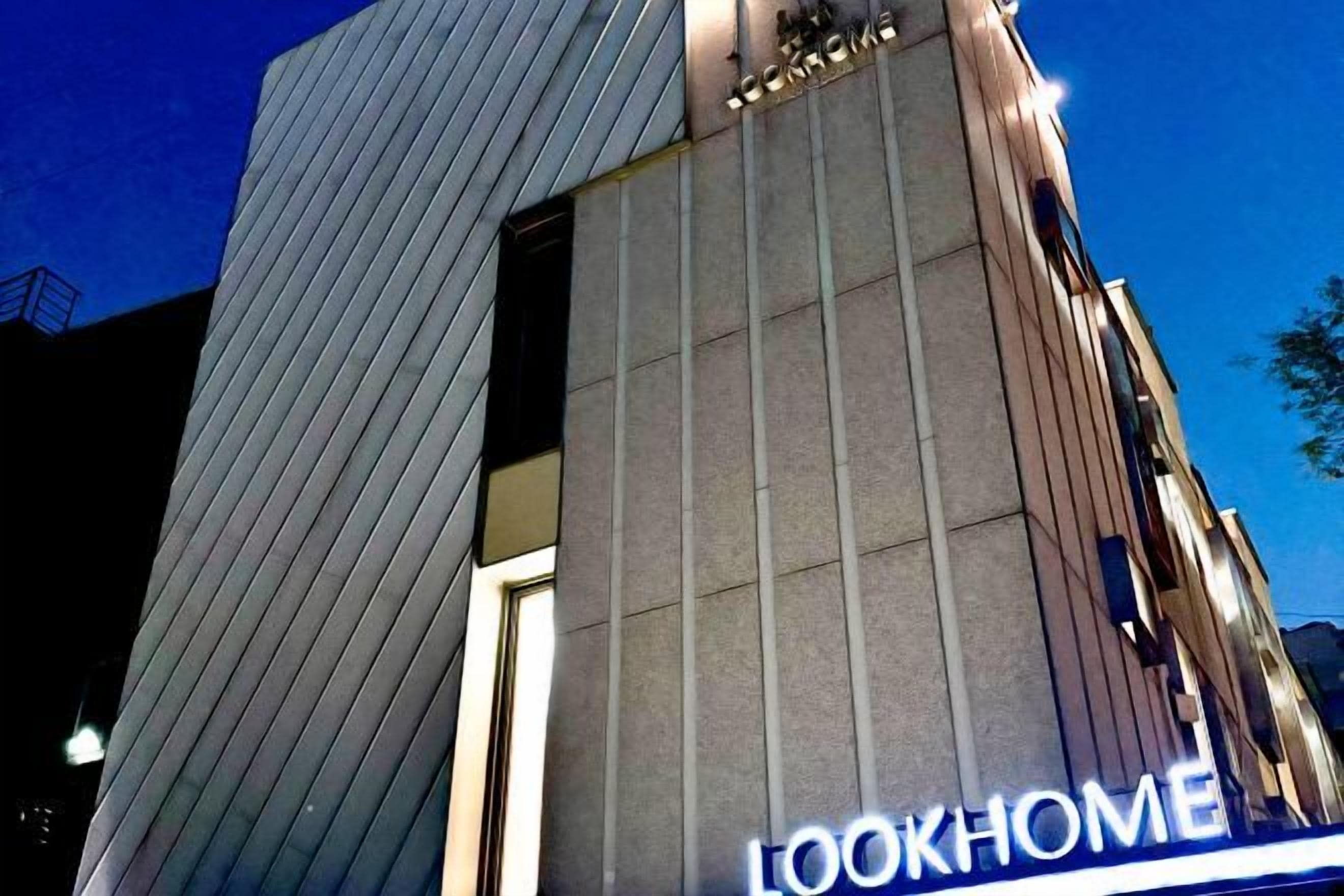 A building with a modern design, featuring a prominent 'LOOKHOME' sign.