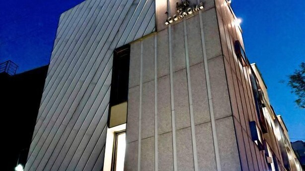 A building with a 'LOOKHOME' sign, featuring a modern design with vertical lines and a mix of materials. - Look Home Guesthouse in Myeong-dong (Seoul)