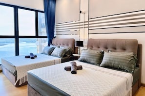 A hotel room with two beds, a large window, and a view.